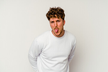 Obraz premium Young caucasian man isolated on white background funny and friendly sticking out tongue.