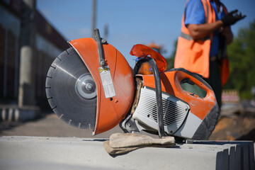Circular saw stands on concrete, close-up.