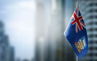 A small flag of Falkland Islands on the background of a blurred background