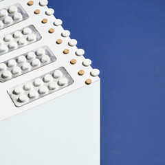 Medicine cold concept. Blue and white cube. Flu pills blister. Healthcare supplement. Fever sick. Aspirin. Pharmaceutical laboratory. Antibiotic treatment. Copyspace