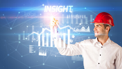 Young businessman with helmet drawing on virutal screen