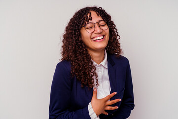 Young business mixed race woman isolated on white background laughs happily and has fun keeping...
