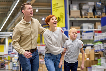 family with child son run to discounted product, hurry up to make purchase