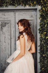 Naklejka premium Beautiful young woman in white wedding dress smiling