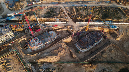 Large construction site. Construction of multi-storey buildings has begun. Tower cranes are standing. Aerial photography of construction.