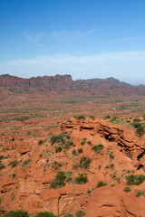 Naklejka premium The arid desert. View of the orange and red sandstone cliffs and mountains under a blue sky. 