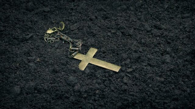 Cross Necklace Drops Onto The Ground