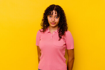 Young mixed race woman isolated on yellow background sad, serious face, feeling miserable and...