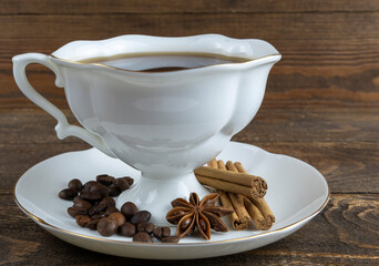 cup of coffee and anise on a wooden background