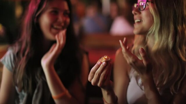 Girls talking talking at a bar seen with blurry vision