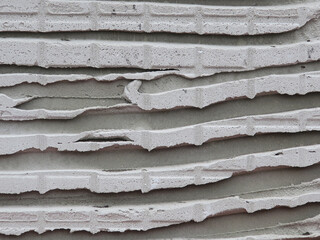 layers of cemnet on an old stone wall