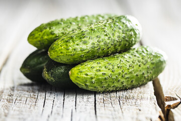 Fresh green cucumbers on wooden table.