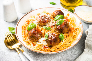 Pasta with Meatballs in tomato sauce at light table.