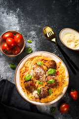 Pasta with Meatballs in tomato sauce at black.