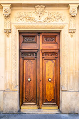 Paris, an ancient wooden door, typical building in the 11e arrondissement

