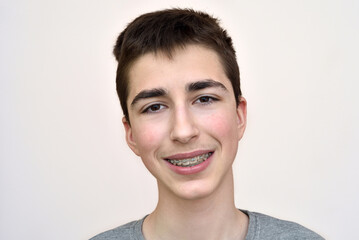 Portrait of a happy smiling teenage boy with dental braces