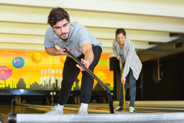 Fototapeta na wymiar recreational staff cleaning the bowling area