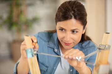 woman replacing light bulb at home