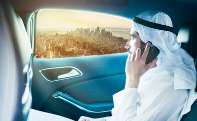 Sheik on the phone in the limo looks out the window.