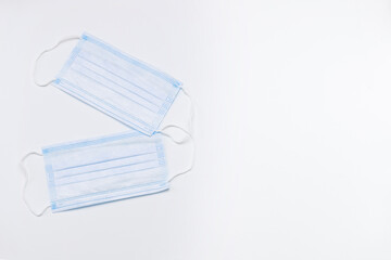 two medical disposable masks on a white background