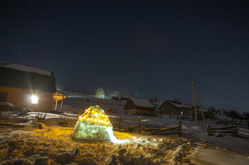 Snow igloo at night in the mountains