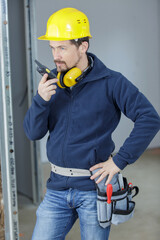 contractor using walkie-talkie to explain employees what to do