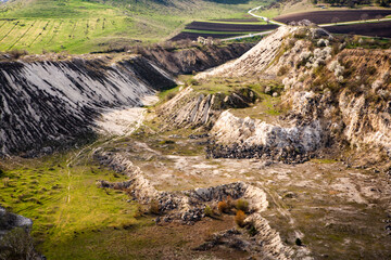 Abandoned limestone quarry. Interesting form of relief. Amazing hills and ground. Dry areas of the earth. Global warming