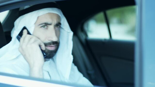 The sheik on the phone arrives with the driver driving the car. International affairs.