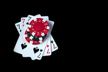 Poker game with a three of a kind or set combination. Chips and cards on the black table in poker club. Free advertising space