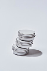 Stack of round cans with facial cream