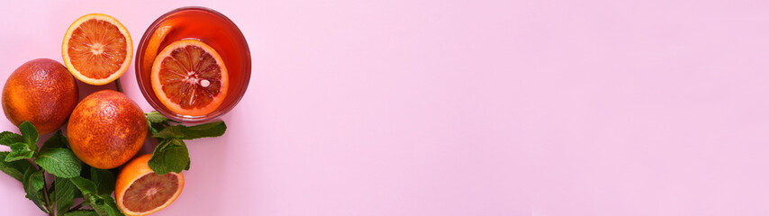 Pop art design, creative summer concept.Creative composition on a pink background with shadows. Red orange juice. Summer minimalist concept 2021.