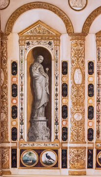 Close-up on old decorative  fresco on a wall, emulating a classical marble sculpture inside a niche