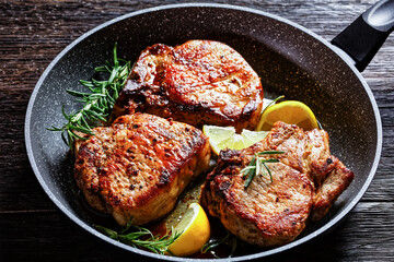 fried pork chops on a skillet, top view