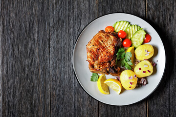 pork cutlets with boiled potato and cucumber