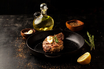 Grilled beef steak in a grill pan with rosemary, garlic and spice - 430248728