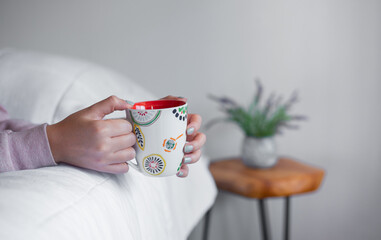 Hand holding a cup of coffee
