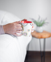 Hand holding a cup of coffee