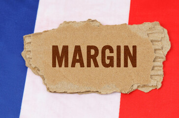 Against the background of the French flag lies cardboard with the inscription - margin