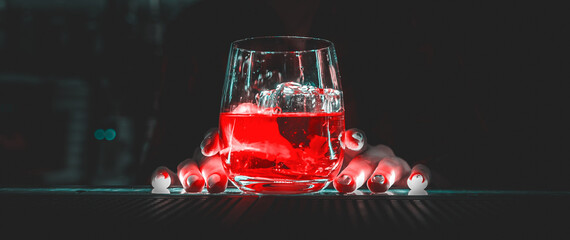 Closeup shot of bartender hand making negroni cocktail. Negroni classic cocktail and gin short...