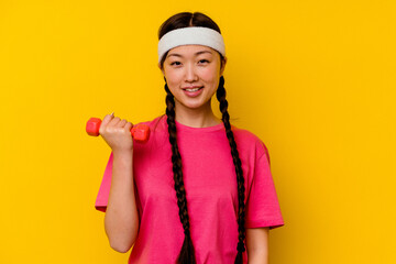 Young sport chinese woman isolated on yellow background happy, smiling and cheerful.