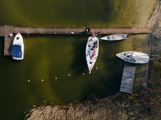 marina for boats, wooden footbridge, Masurian lakes. Aerial view, photos from the drone - obrazy, fototapety, plakaty