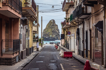 One of the Cyclopean Isles seen from street in Aci Trezza township on Sicily Island, Italy