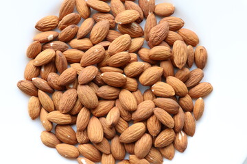 Top view of almond nuts on white plate.Healthy snack