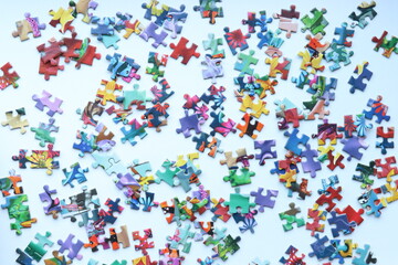 Top view of bright colored puzzles on light background 