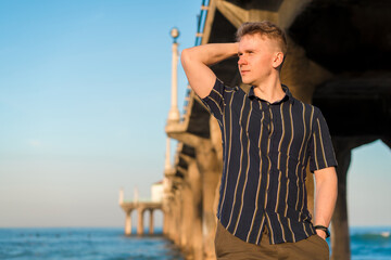 Charming blonde man walks around Manhattan Beach in the early morning in Los Angeles