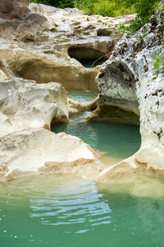 Mirna river flows, forming waterfalls and hollowing cauldron-like forms in stone