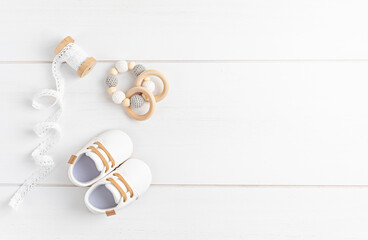 Gender neutral baby shoes and accessories. Organic cnewborn fashion, branding, small business idea - obrazy, fototapety, plakaty