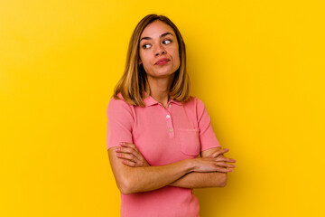 Obraz premium Young caucasian skinny woman isolated on yellow background dreaming of achieving goals and purposes