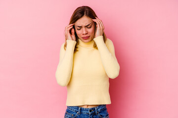 Young caucasian woman isolated on pink background touching temples and having headache.