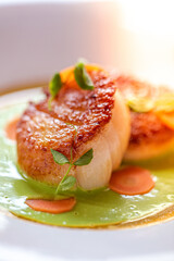 scallop dish served with vegetables at a fine dining restaurant